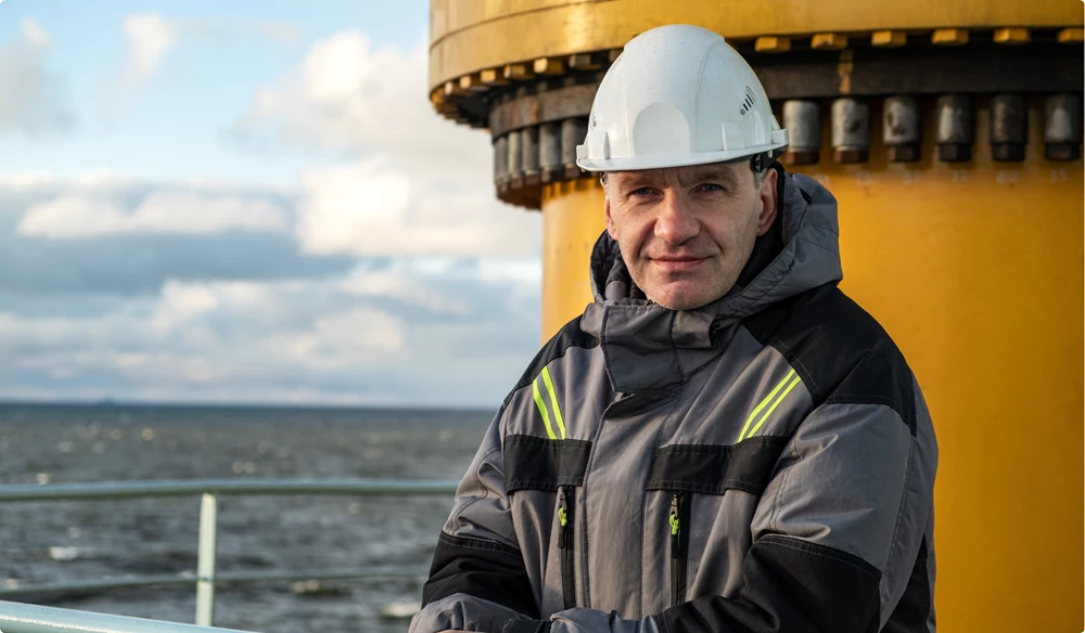Oil rig crew on ship smiling at the camera