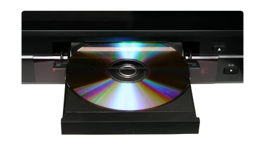 A DVD or Blu-ray disc being inserted on a player which is covered by the Filmbankmedia Blanket Licence