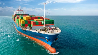 A cargo vessel is gliding across the ocean