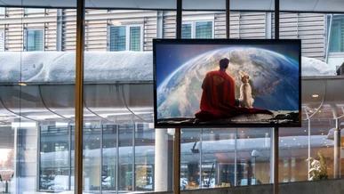 Superman is being played on a TV screen in a common room on the premises of a business