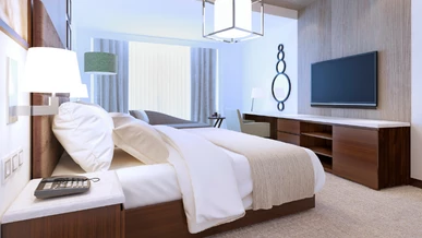 A luxurious hotel room with a TV screen on the wall